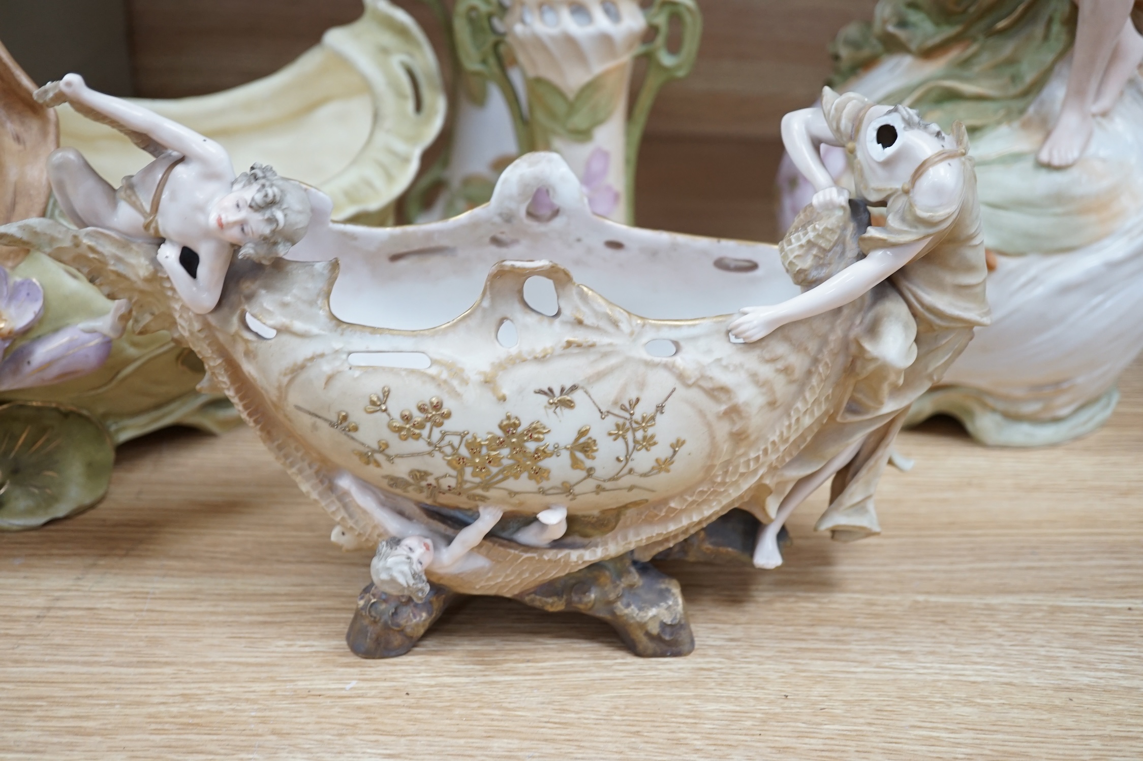 Five Royal Dux vases, including a pair of spill vases and a German porcelain boat shaped vase, largest 48cm high. Condition - four good, boat shaped vase poor